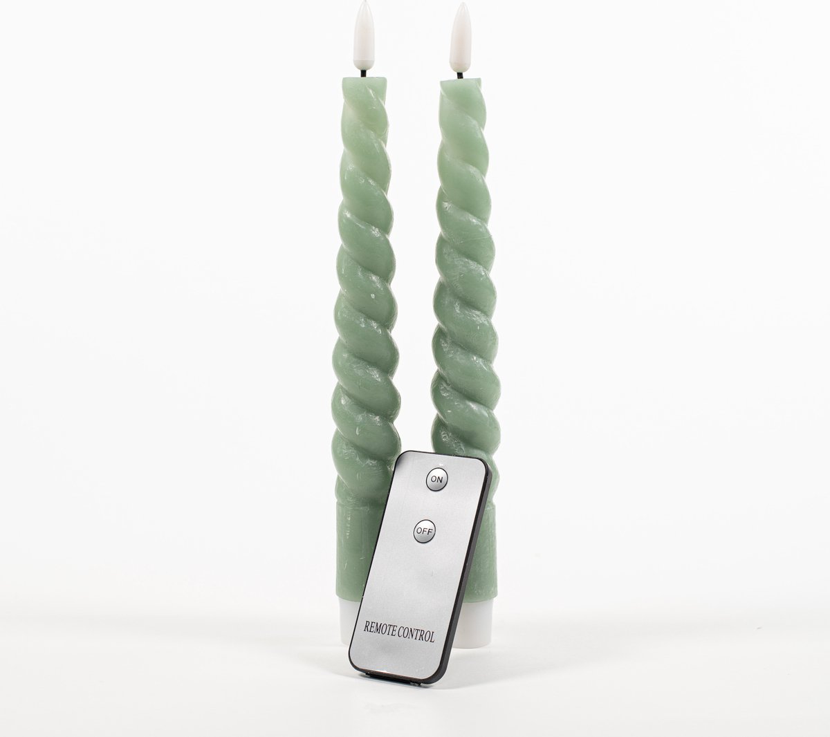 Two green twisted LED candles with a remote control